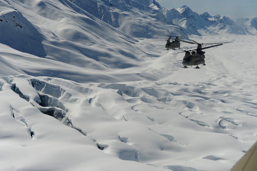 Two Chinook Helicopters pass over a crevasse field as Fort Wainwright soldiers haul tents, fuel and food up to the Kahiltna Glacier for the National Park Service Denali mountaineering camp on Sunday, April 24, 2016. Bob Hallinen / ADN