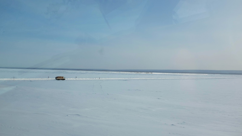 A truck driving across the frozen Lena River from the village of Bestyakh. Photo by Mia Bennett