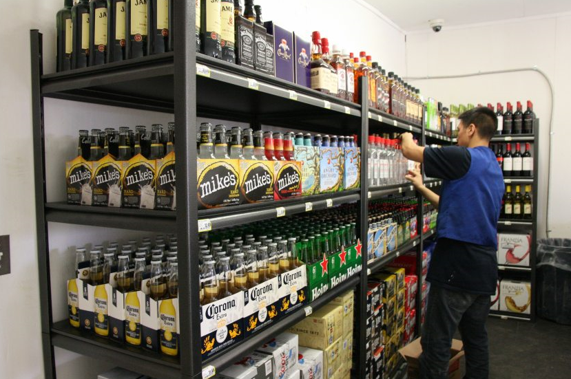 An Alaska Commercial Co. worker stocks the shelves of the AC liquor store in Bethel, Alaska, on opening day, Tuesday, May 3, 2016. The new liquor store offers the first legal sales of alcohol in Bethel in more than 40 years. (Lisa Demer/Alaska Dispatch News)