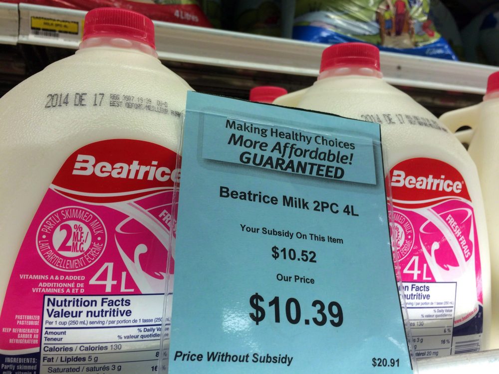 A price tag lists the price and subsidy of a 4-litre jug of milk at a grocery store in Iqaluit, Nunavut on December 8, 2014. (Sean Kilpatrick/THE CANADIAN PRESS)