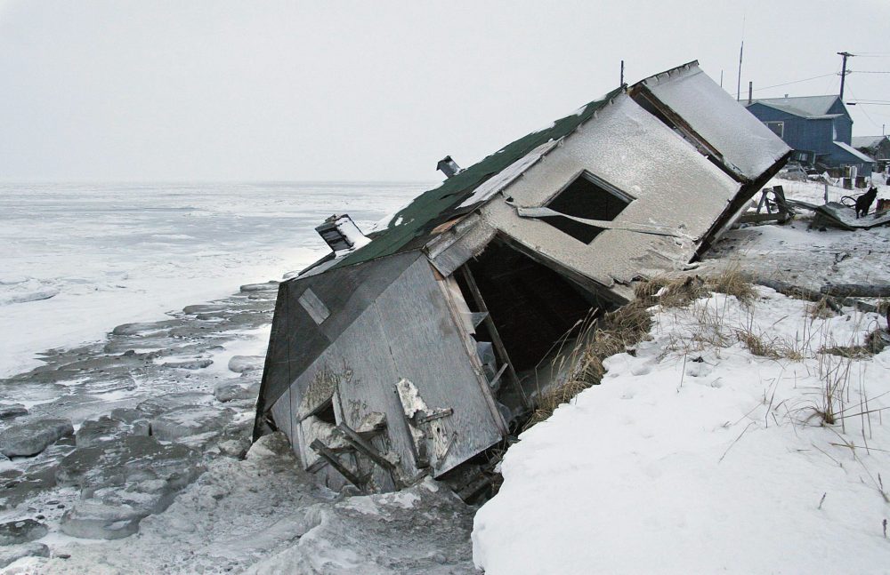 Nathan Weyiouanna's abandoned house at the west end of Shishmaref, Alaska, Dec. 8, 2006, sits on the beach after sliding off during a fall storm in 2005. Like some other Alaska villages, the Inupiat community of 600 is facing an expensive relocation because of erosion, which is eating away at the current site on a narrow island just north of the Bering Strait. (Diana Haecker/AP Photo)