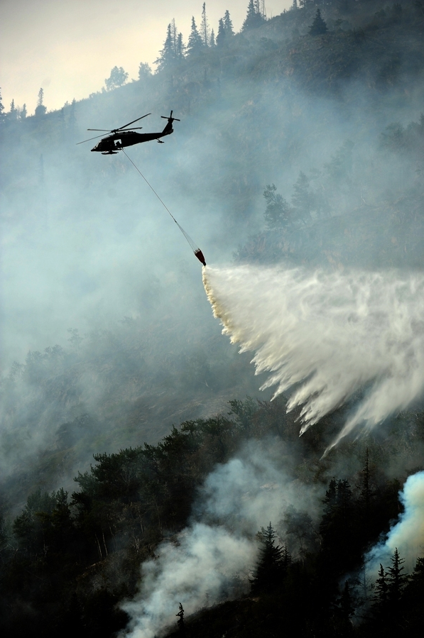 Helicopters dropping water work the McHugh Creek wildfire along the Seward Highway on Wednesday. (Bob Hallinen / Alaska Dispatch News)