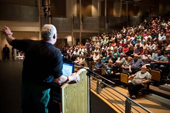 McHugh fire Incident Commander Tom Kurth talks to an audience of community members at South High School Wednesday evening. (Marc Lester / Alaska Dispatch News)