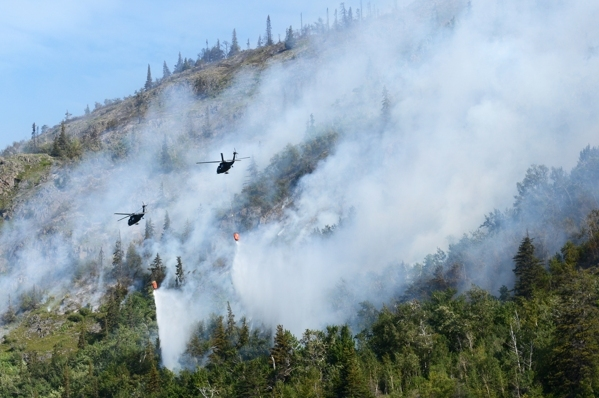 Alaska National Guard helicopters drop water on the McHugh Creek wildfire as it continues to burn near Beluga Point on Wednesday, July 20, 2016, along Turnagain Arm. (Erik Hill / Alaska Dispatch News)