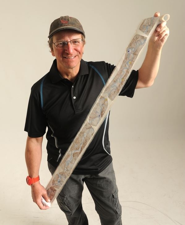 Denis Morin holds the map of the Yukon River he used on his swim from Whitehorse, Yukon, to Emmonak, Alaska in the Alaska Dispatch News studio on Wednesday, August 10, 2016 in Anchorage. (Bob Hallinen / Alaska Dispatch News)