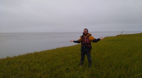 Denis Morin stands on the coast near Emmonak, at the Bering Sea. (Denis Morin)