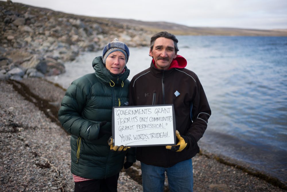 Actor, writer and activist, Emma Thompson and former mayor of Clyde River, Jerry Natanine hold a sign near Clyde River. (Greenpeace)