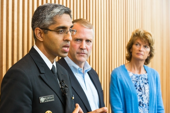 U.S. Surgeon General Vivek Murthy, with senators Dan Sullivan and Lisa Murkowski, speaks to reporters at the Wellness Summit at the Glenn Massay Theater on Thursday. (Loren Holmes / Alaska Dispatch News)