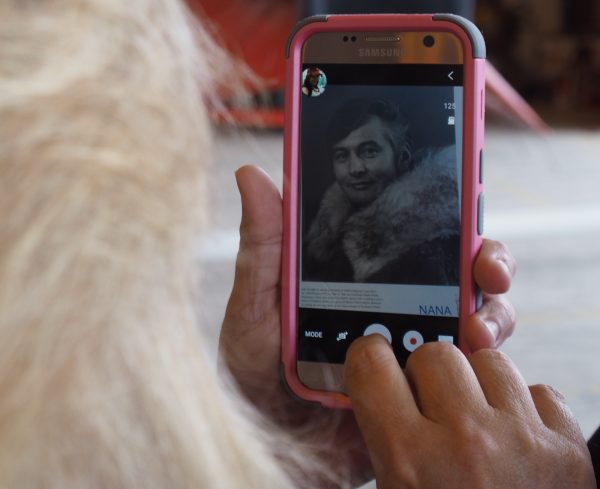 An attendee snaps a picture of a much younger Maj. Gen. John W. Schaeffer Jr. ahead of the ceremony. (Zachariah Hughes/ Alaska Public Media – Kotzebue)