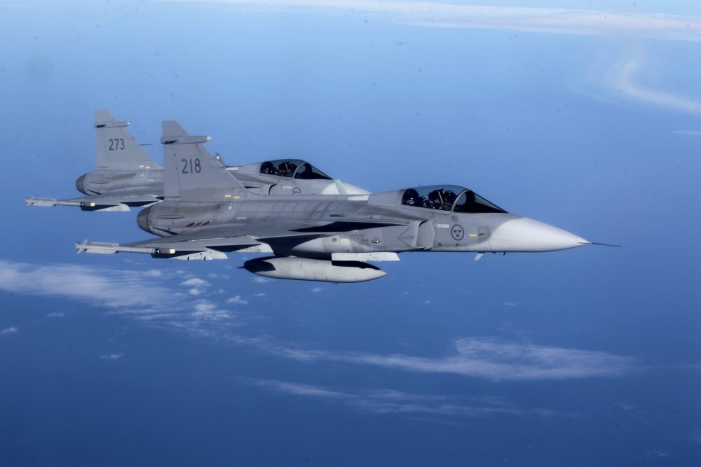 Sweden's Air Force "Grippen" fighters are seen as they escort a Lithuania's Air Force C-27J plane during NATO joint military exercise in Siauliai April 1, 2014. (Ints Kalnins / REUTERS)
