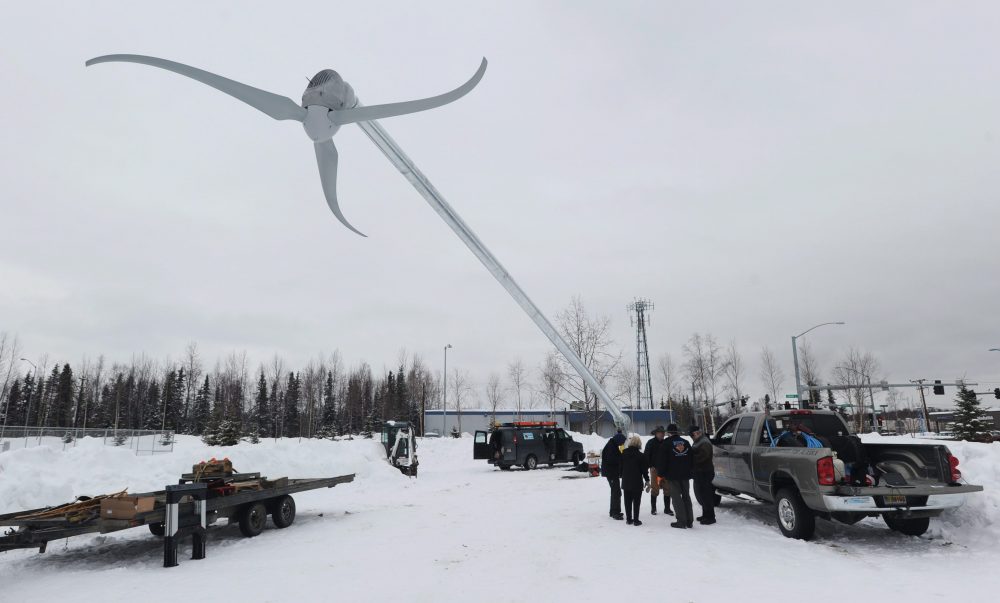 A screw lift slowly raises a 70-foot wind turbine into position at Begich Middle School in east Anchorage, Alaska on Monday, Feb. 27, 2012. The installation is part of the Alaska Wind for Schools program, a collaboration between the UAF Alaska Center for Energy and Power, the Renewable Energy Alaska Project, and the U.S. Dept. of Energy. (Erik Hill/AP Photo/The Anchorage Daily News)