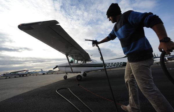 Student pilot Cole Harkovitch fuels a Cessna 172 before going up in the air with a flight instructor from Land and Sea Aviation Alaska at Merrill Field. (Bill Roth / Alaska Dispatch News)