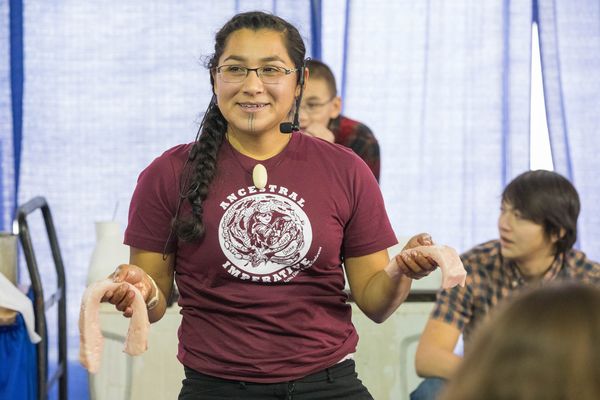 Holding seal blubber, Marjorie Tahbone, an Inupiaq from Nome, explains how it is rendered into seal oil during a seal butchering demonstration on the first day of the Elders and Youth Conference at the Carlson Center in Fairbanks on Monday, Oct. 17, 2016. (Loren Holmes / Alaska Dispatch News)