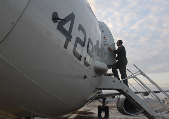 A U.S. Naval Aircrewman enters a P-8A Poseidon, military maritime surveillance aircraft, in Malaysia in 2014. (Mass Communication Specialist 2nd Class Eric A. Pastor/U.S. Navy/Getty Images)