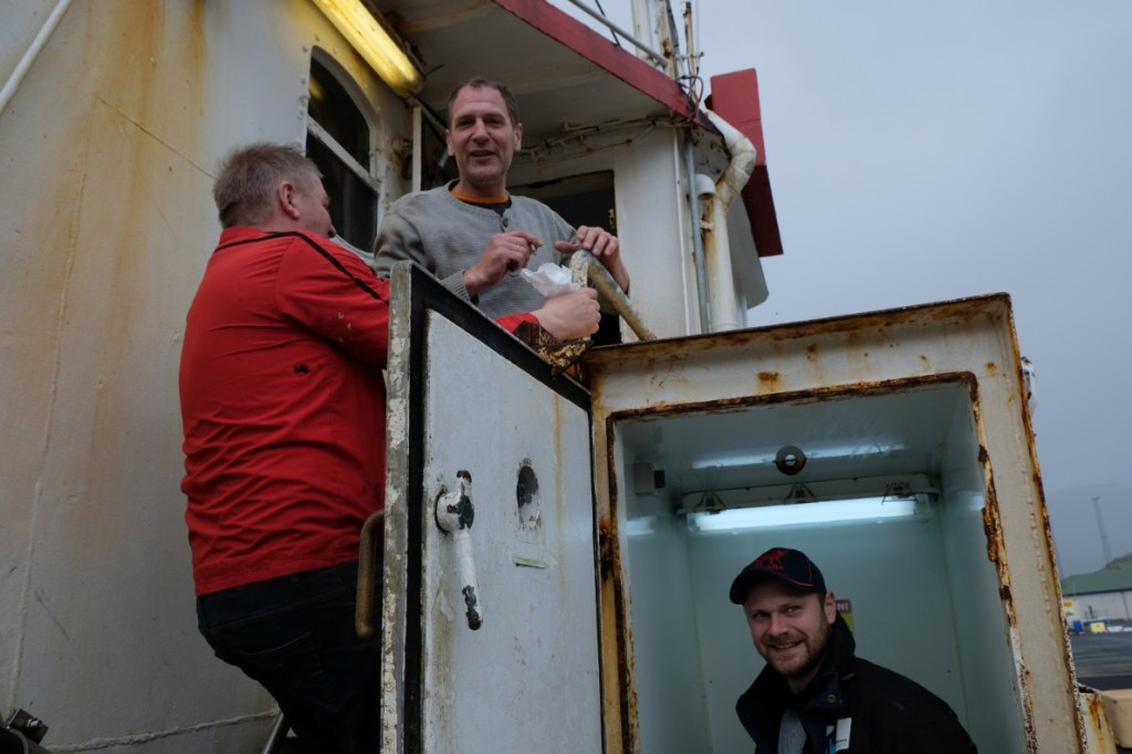 Fishermen docked in the town of Eiði.