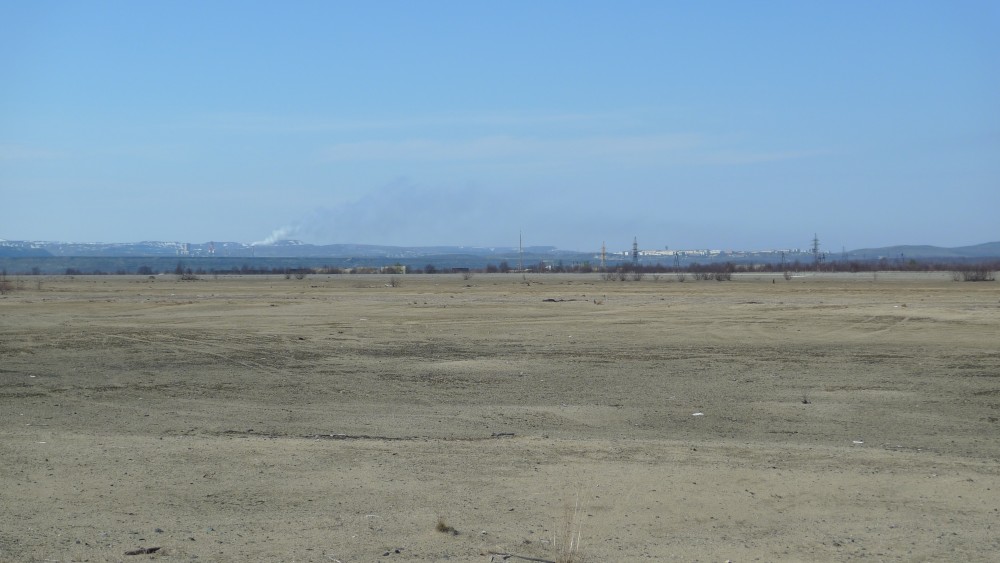 The mining town of Zapolyarny visible in the horizon from the huge closed down air base. (Thomas Nilsen/The Independent Barents Observer)