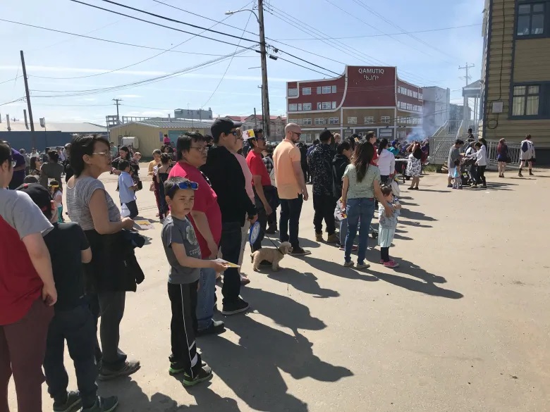 People mill around Iqaluit’s Four Corners in the city’s downtown core. (Sara Frizzell/CBC)