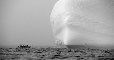 A boat approaches a massive iceberg in Lancaster Sound. Some pleasure craft will be prohibited from sailing in Arctic waters until at least the end of October.