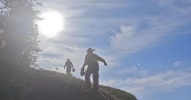 Fire crews make their way up a slope near Fort Good Hope.