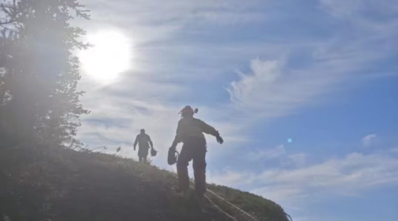 Fire crews make their way up a slope near Fort Good Hope.