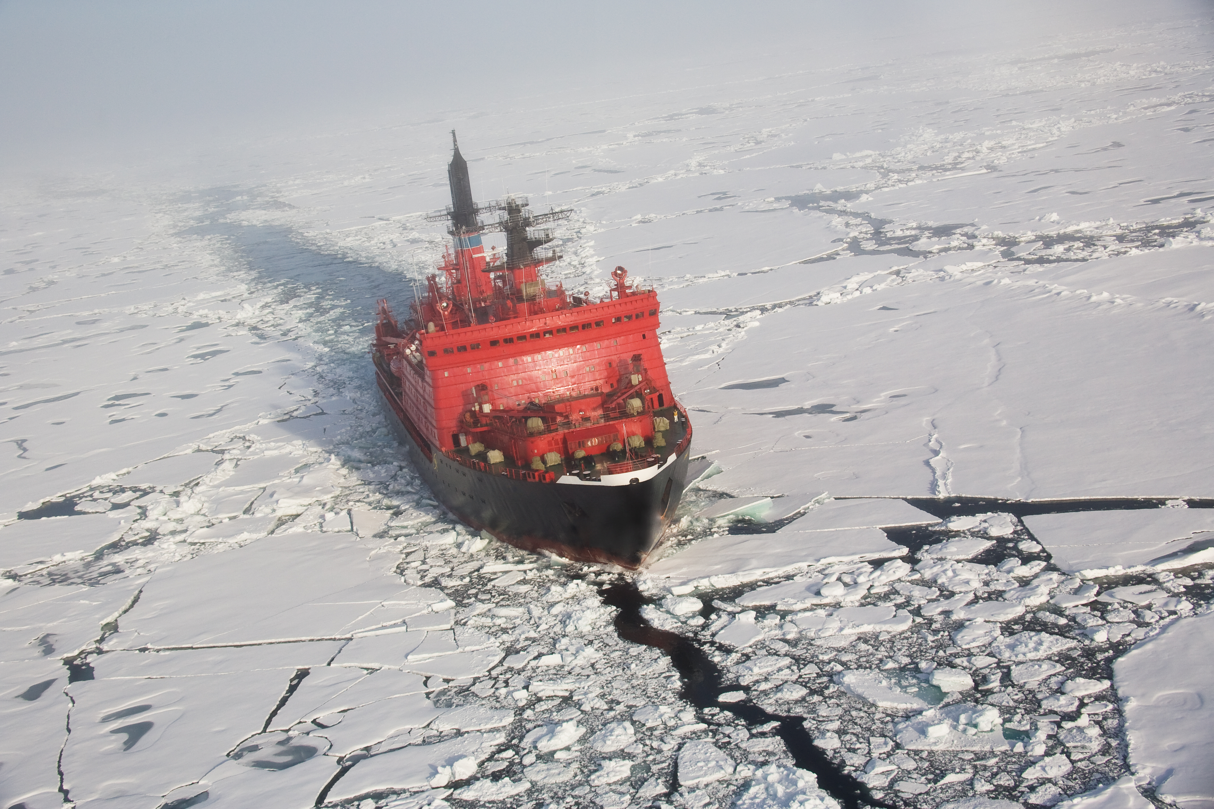 A red nuclear ice breaker ship in iceberg water 