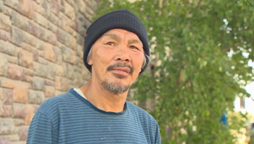 Adolf Hakuluk wears a stripped shirt and toque