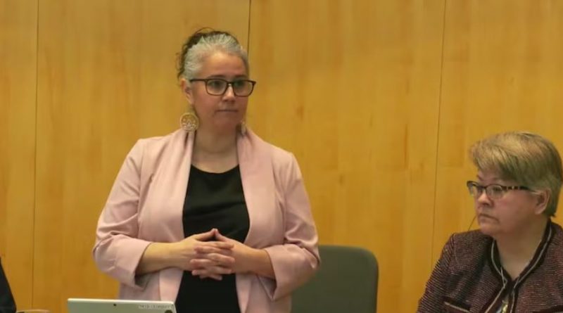 Woman in blazer stands