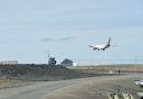 A charter plane on final approach to an airport.