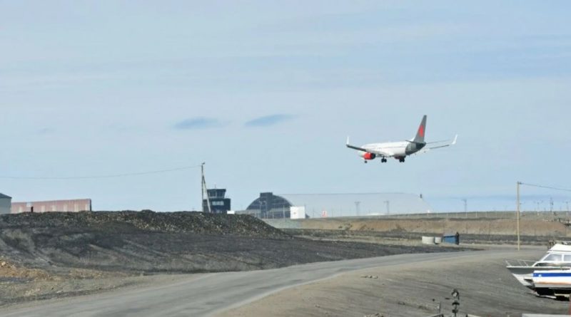 A charter plane on final approach to an airport.