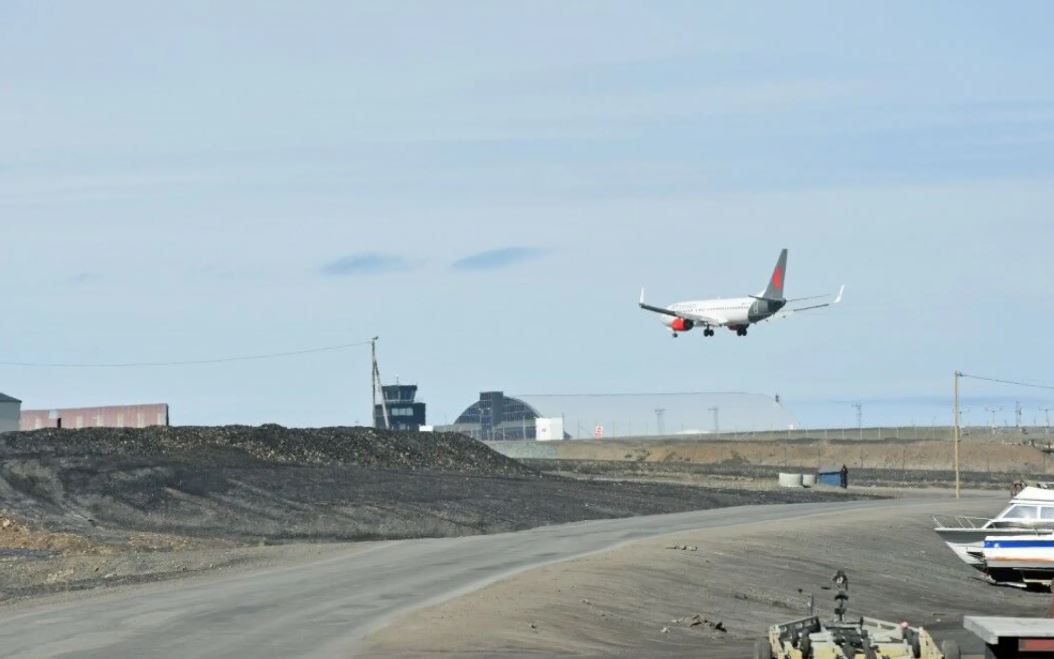 A charter plane on final approach to an airport.