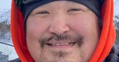 A man, smiling.