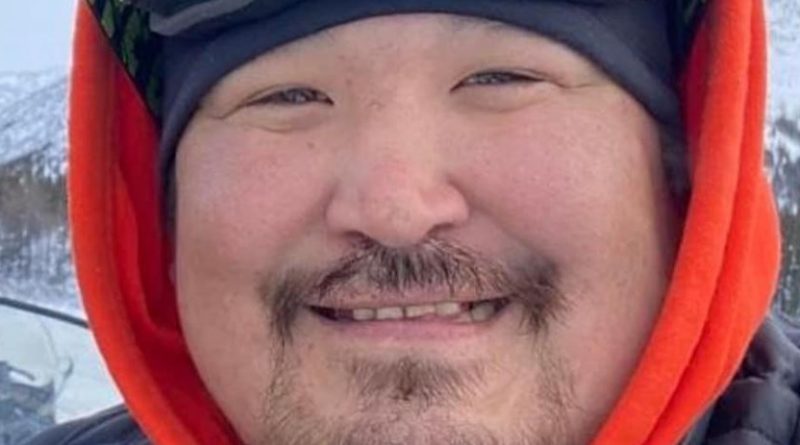 A man, smiling.