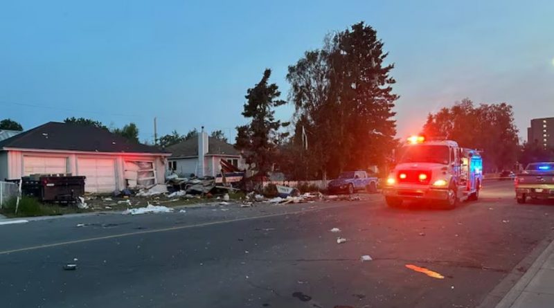 Debris on a street and an fire truck with lights on.