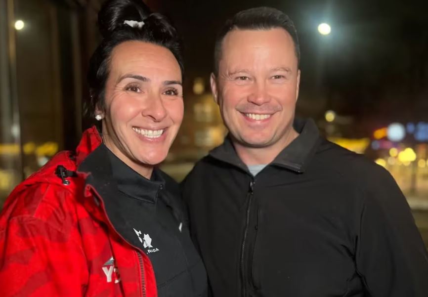A woman in a red jacket and a man in a black jacket.