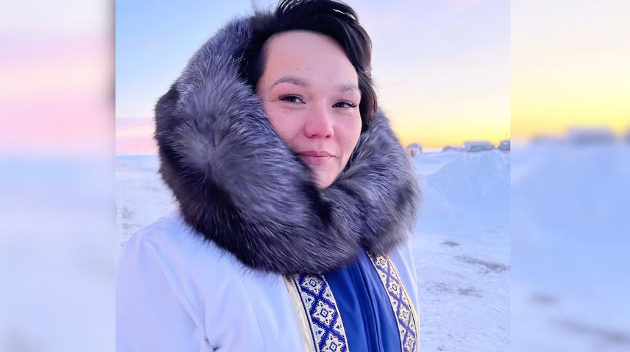 Woman in parka looks at camera