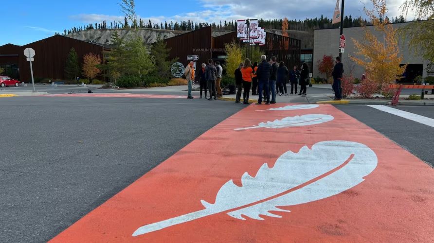 White feathers on orange crosswalk