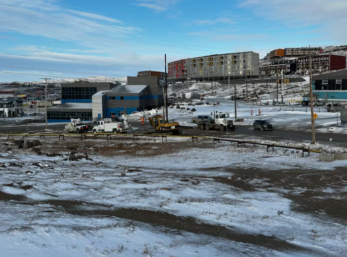 Equipment parked near power lines in Iqaluit.