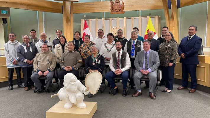 Politicians sit together for photo