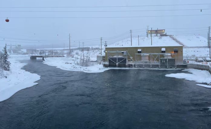 A river below a power dam in winter.
