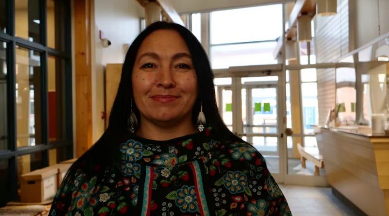 A portrait of a smiling woman.