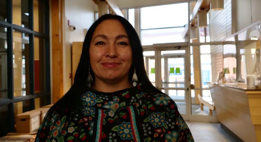 A portrait of a smiling woman.