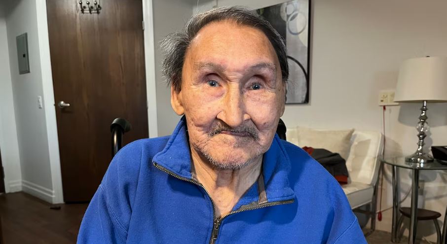 A man in a blue sweater sits for photo.John Amagoalik speaks with CBC Indigenous in Ottawa in April 2026.