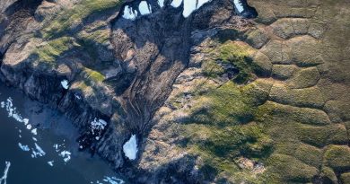 A aerial shot of a deep depression along a coastline.