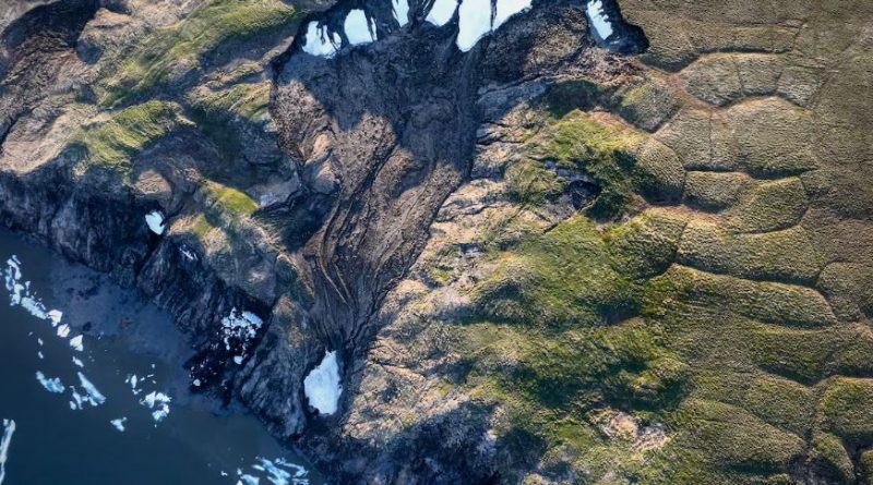 A aerial shot of a deep depression along a coastline.
