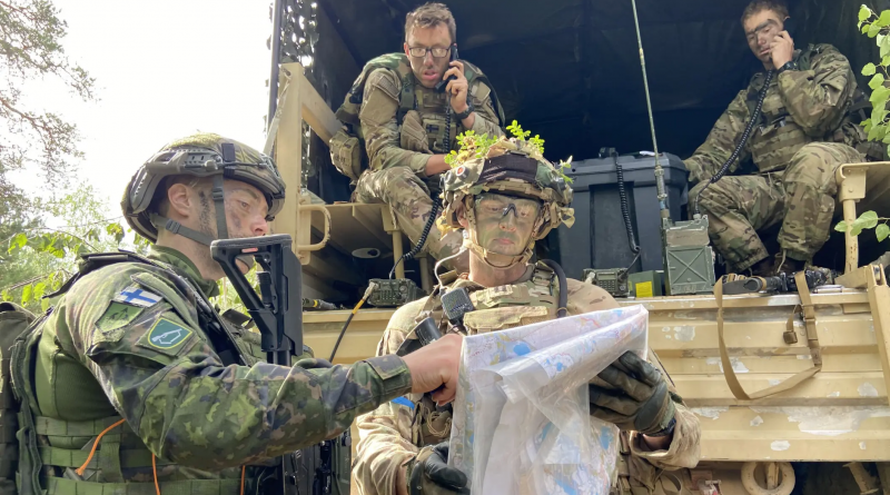 Military men looking at a map