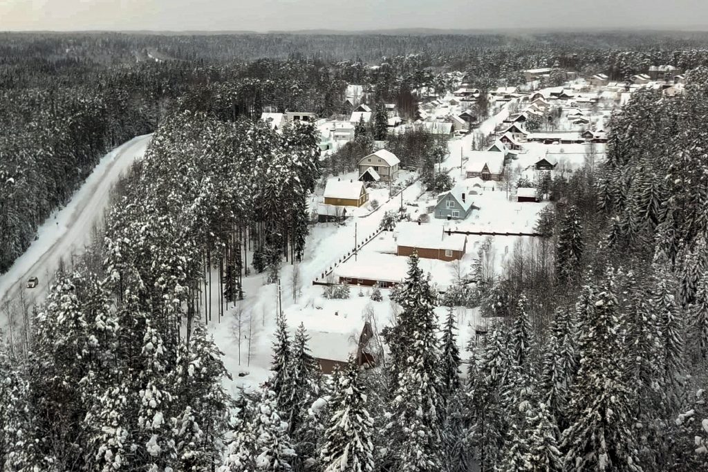 Snow coats the village of Ikhala in Russia’s Karelia region, Tuesday, Feb. 16, 2021. Russia’s rollout of its coronavirus vaccine is only now picking up speed in some of its more remote regions, although experts say the campaign is still moving slowly. (AP Photo/Kirill Zarubin)