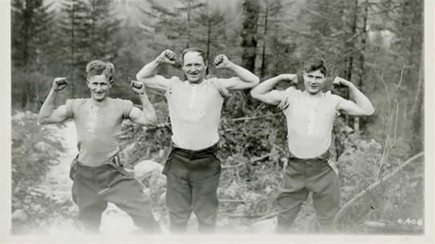 Trois membres du Corps forestier canadien en Europe. La solide réputation des robustes bûcherons canadiens a mené à la création du Corps forestier canadien en 1916. Près de 24 000 bûcherons du Canada se sont rendu en Europe à cette époque. Photo Credit: Archives George-Metcalf