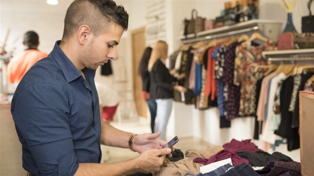 Un employé dans une boutique de vêtements Photo : iStock/Max Riesgo