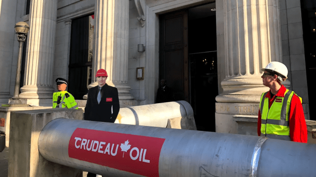 Justin Trudeau devant le pipeline en carton de Greenpeace - Photo : Radio-Canada