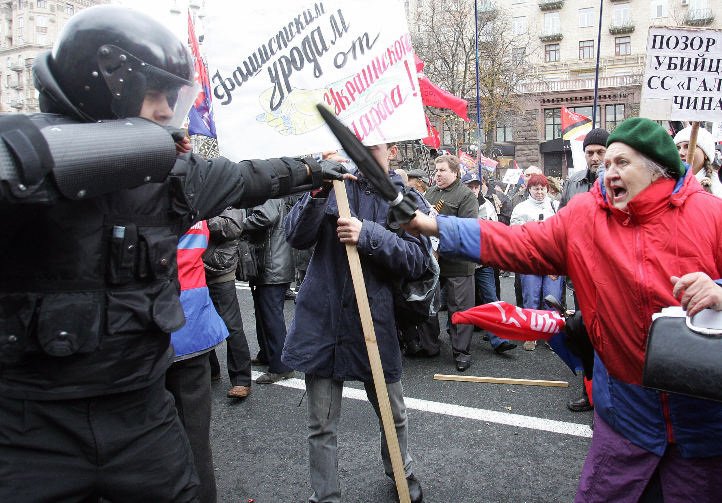 Activists of the ultra-left wing Progressive Socialists party clash with police forces blocking a main street during a protest action in central Kiev 14 October 2007. Police were trying to separate left-wing demonstrators and Ukrainian nationalists marking the 65th anniversary of the founding of a Ukrainian Insurgents Army (UPA), a World War Two guerrilla movement that fought both Nazi invaders and Soviet forces. AFP PHOTO / SERGEI SUPINSKY (Photo credit should read SERGEI SUPINSKY/AFP/Getty Images)